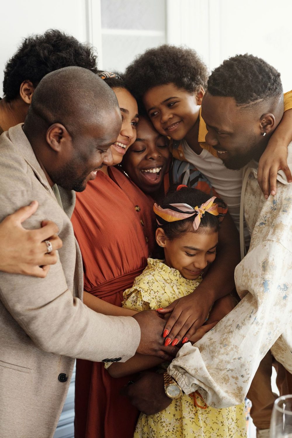 A multigenerational family embracing in a warm group hug