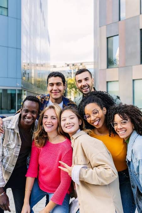 A diverse group of friends together outside a city building